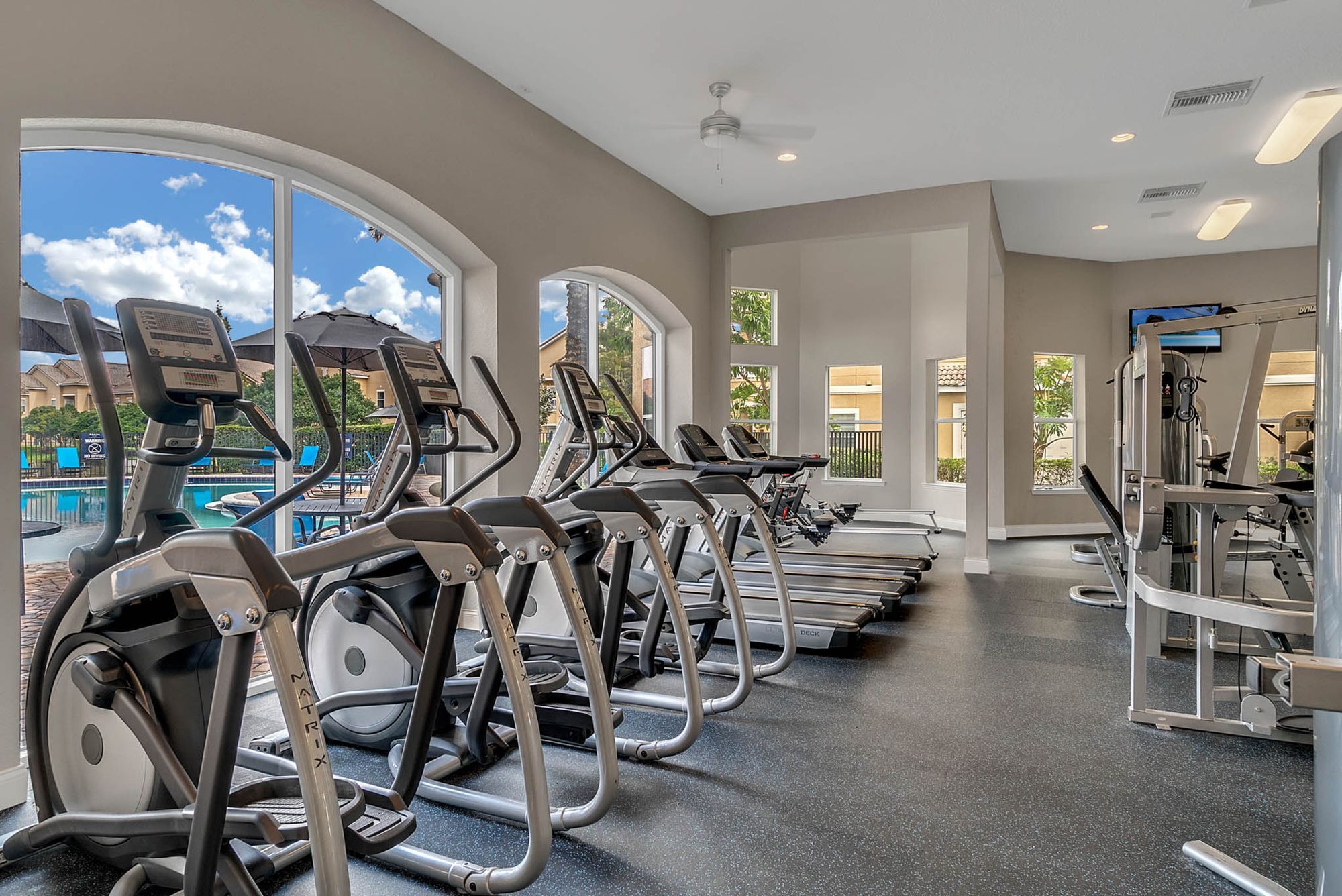 Fitness Center with cardio equipment overlooking pool