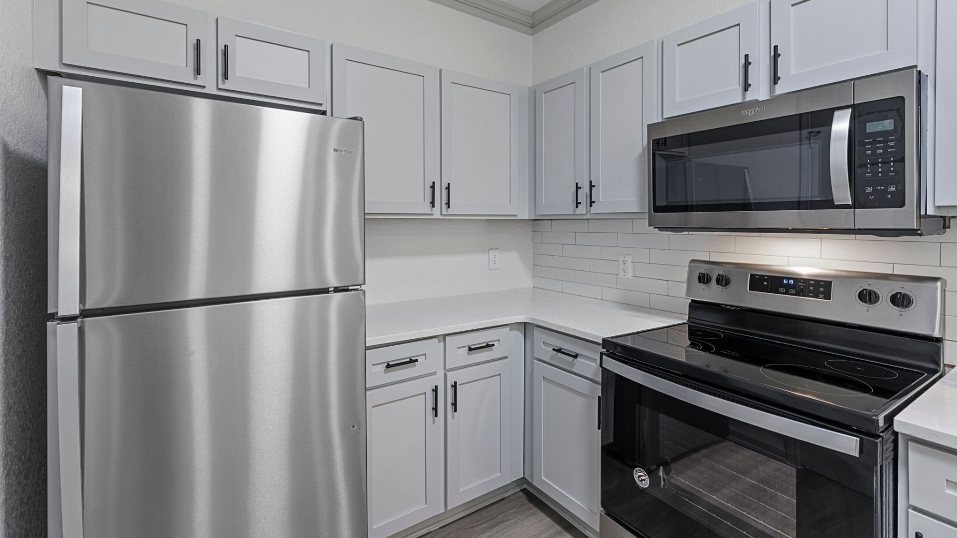 Renovated Kitchen with Quartz countertops, stainless steel appliances, and black hardware
