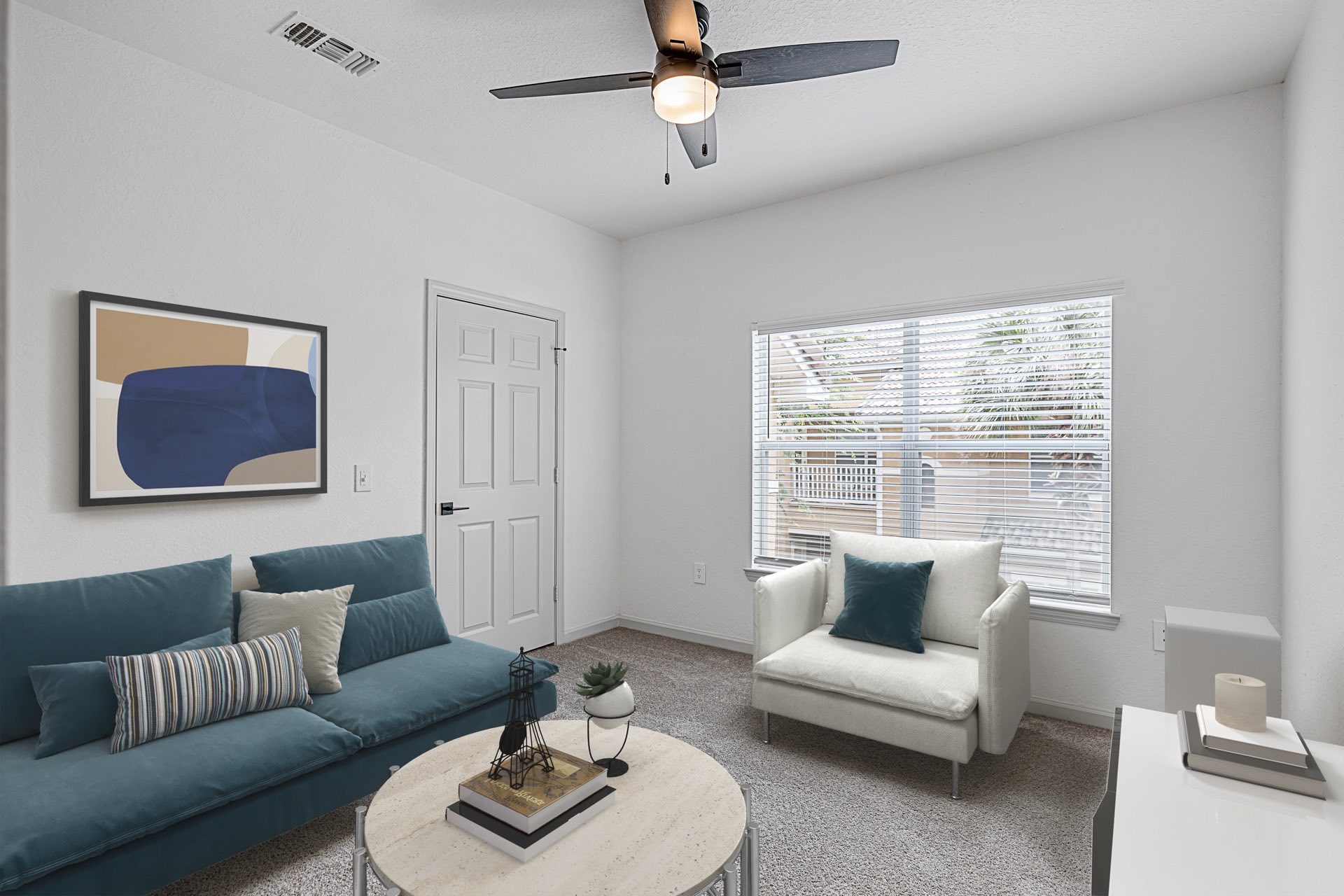living room with large window and upgraded ceiling fan